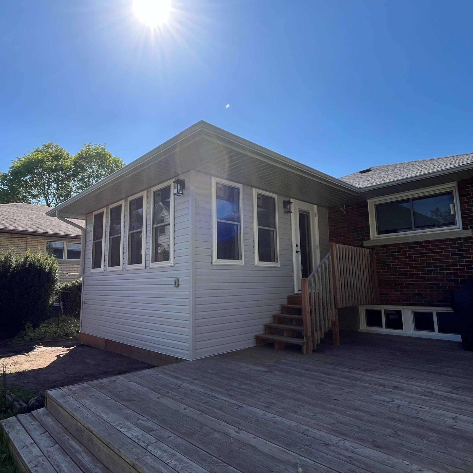Modern home addition with deck and dark trim